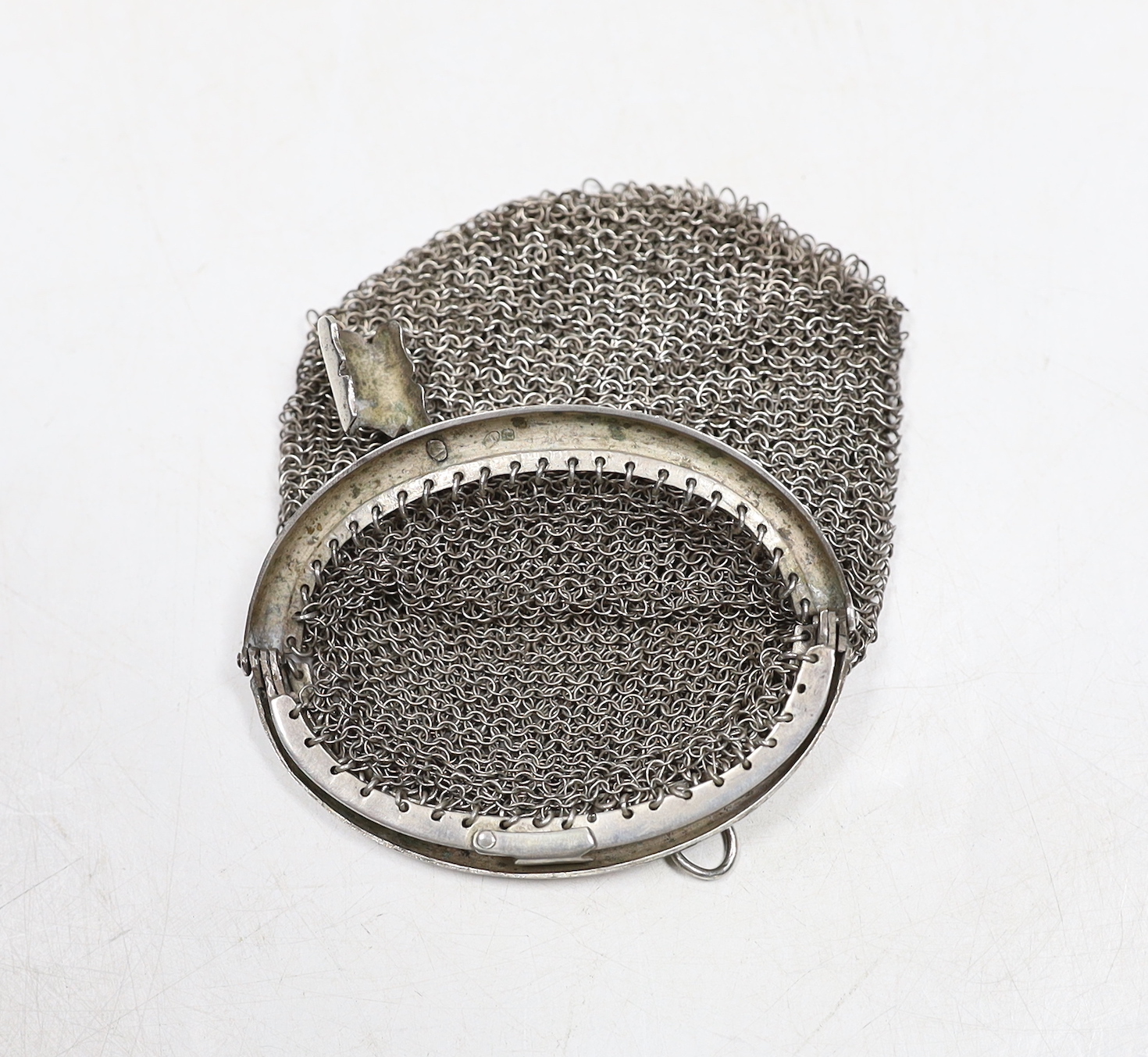A miser's purse on suspension chain, together with a mesh evening purse.